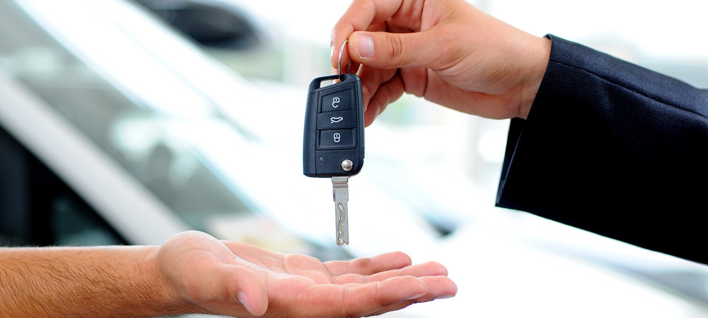 Salesperson handing customer keys